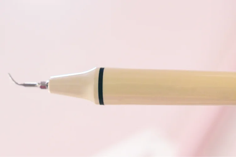 Ultrasonic dental scaler used by dental professionals trained to mitigate the risks of enamel damage, gum irritation, inadequate cleaning, and infection.